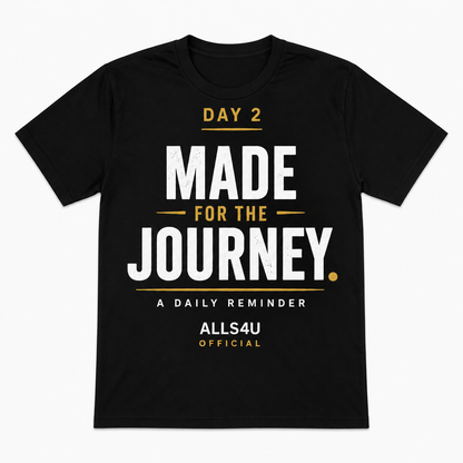 A black short-sleeve t-shirt with a motivational graphic on the front reading 'DAY 2 MADE FOR THE JOURNEY. A DAILY REMINDER ALLS4U OFFICIAL' in white and gold text, shown on a plain white background.