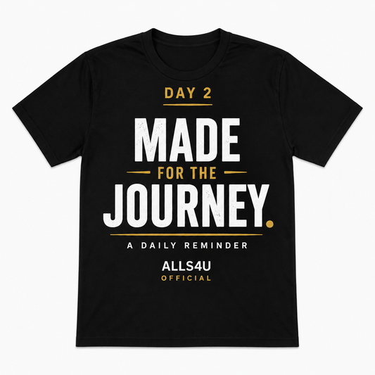 A black short-sleeve t-shirt with a motivational graphic on the front reading 'DAY 2 MADE FOR THE JOURNEY. A DAILY REMINDER ALLS4U OFFICIAL' in white and gold text, shown on a plain white background.