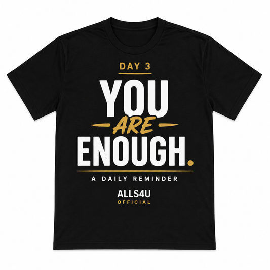 A black short-sleeve t-shirt with a motivational graphic on the front reading 'DAY 3 YOU ARE ENOUGH. A DAILY REMINDER ALLS4U OFFICIAL' in white and gold text, shown on a plain white background.