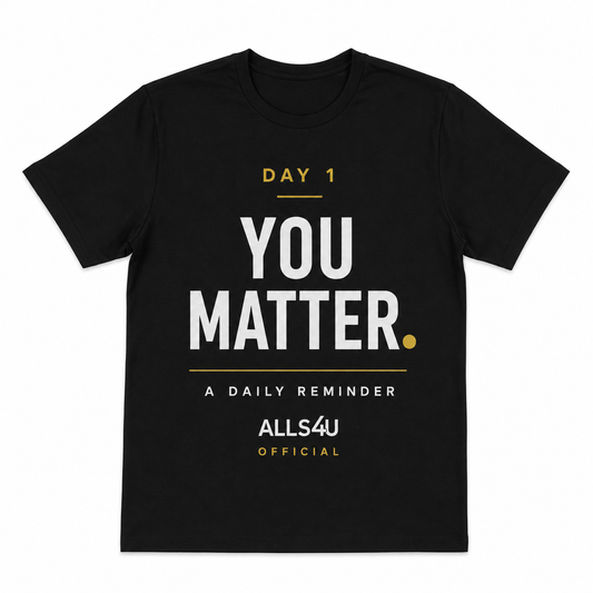 A black short-sleeve t-shirt with a motivational graphic on the front reading 'DAY 1 YOU MATTER. A DAILY REMINDER ALLS4U OFFICIAL' in white and gold text, shown on a plain white background.
